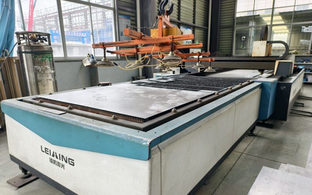 Laser cutting equipment inside the SXFireplace factory