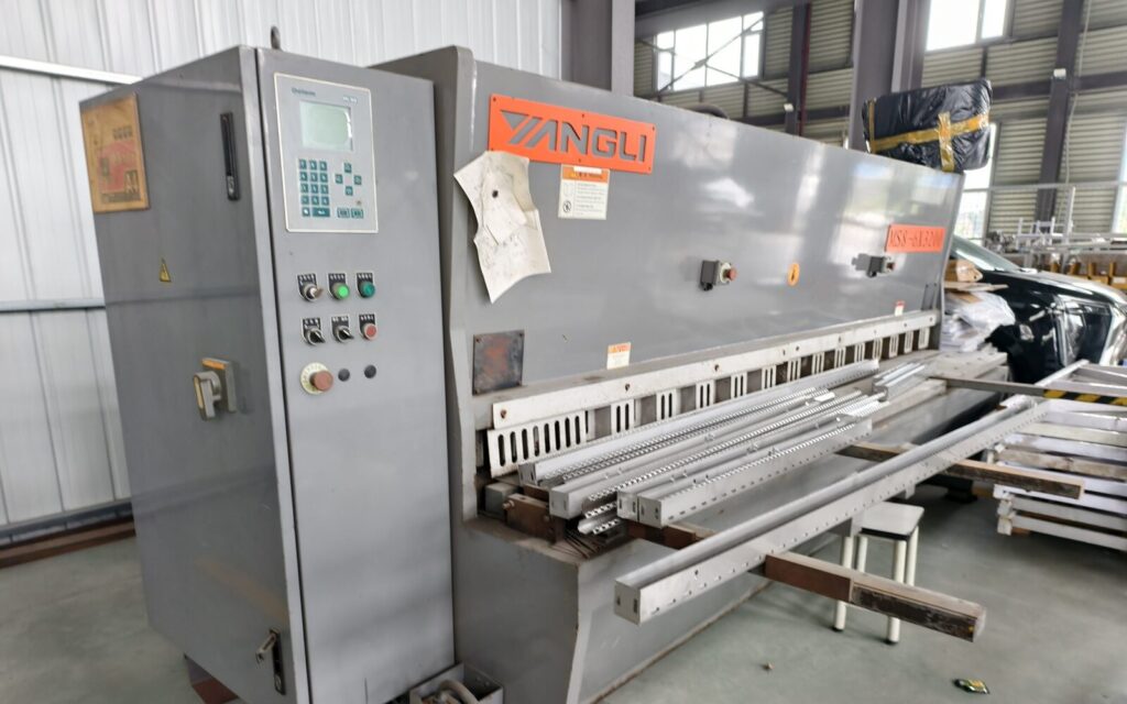Precision metal shearing equipment inside the SXFireplace factory