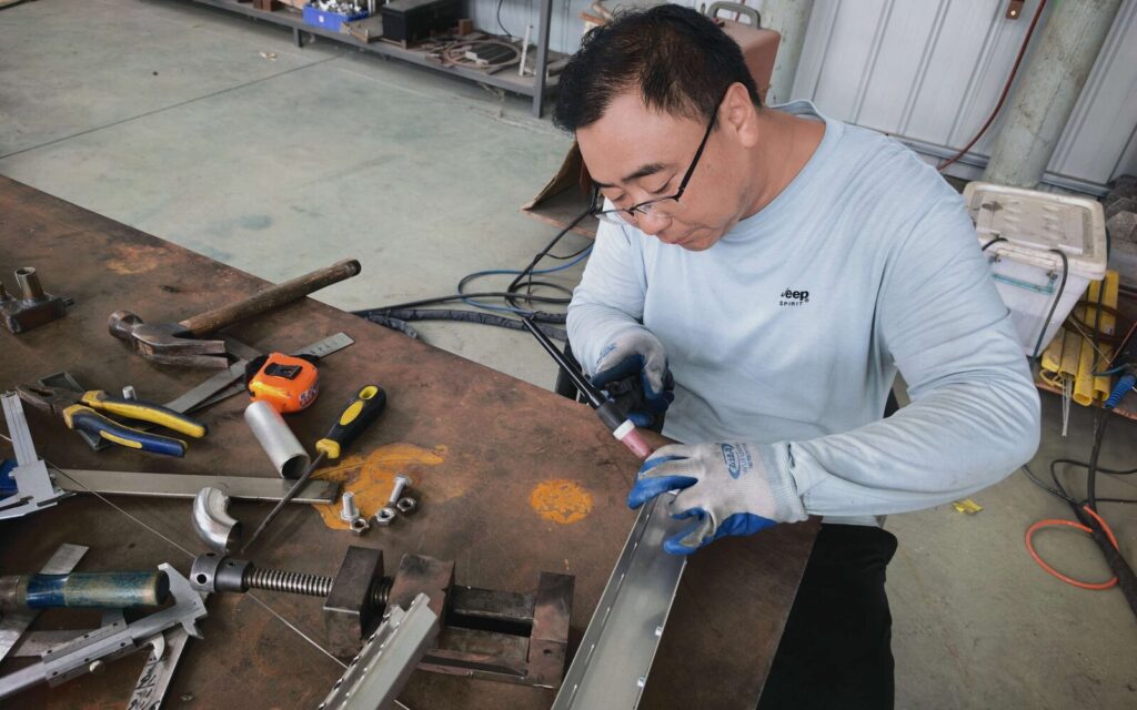 SXFireplace worker TIG welding a stainless-steel fireplace component