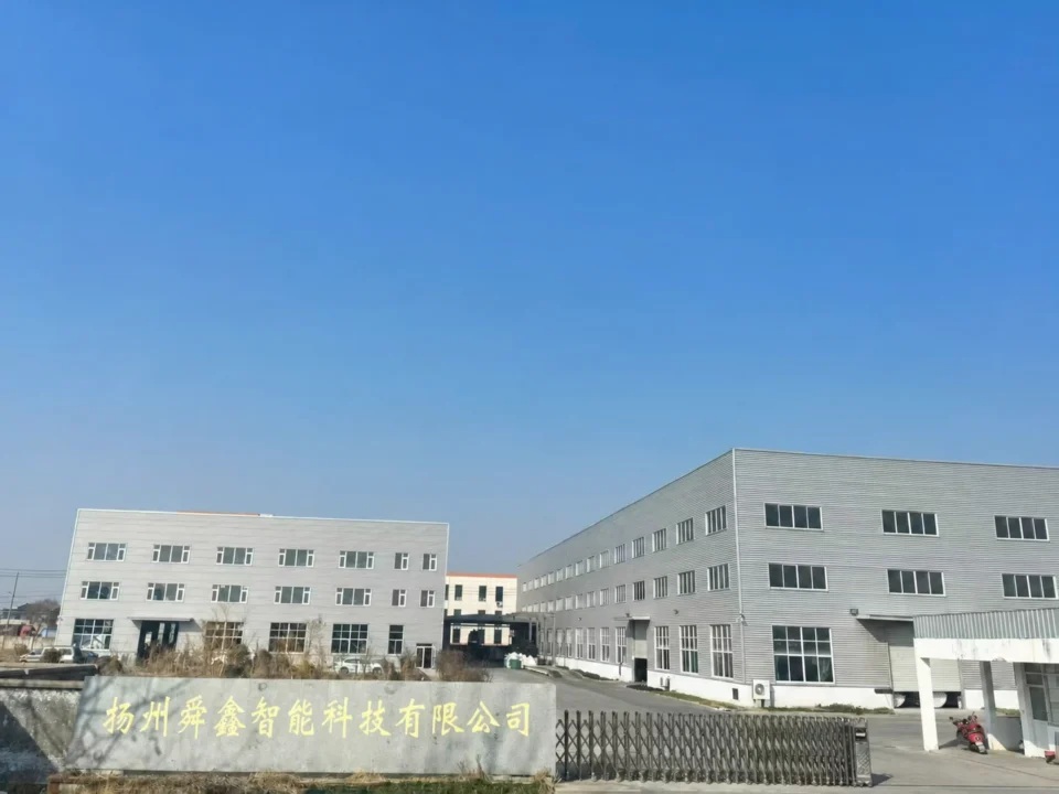 Factory entrance and buildings with the Yangzhou Shunxin company name on the entrance wall.