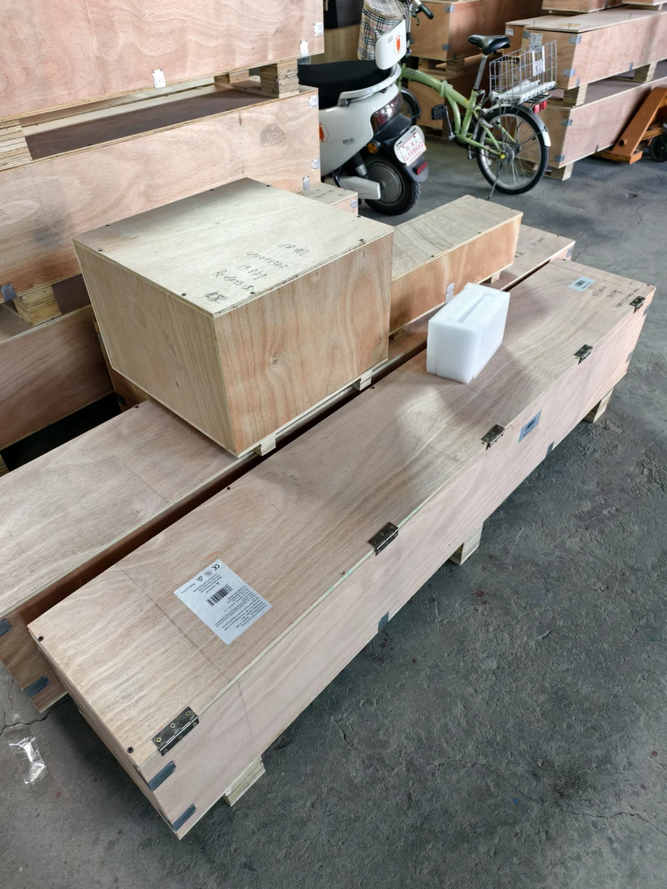 Wooden packing cases and protective foam in the packing area.