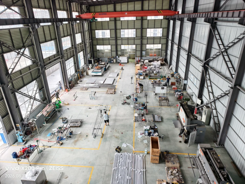 Elevated view of machinery, workstations and metal components across the workshop floor.